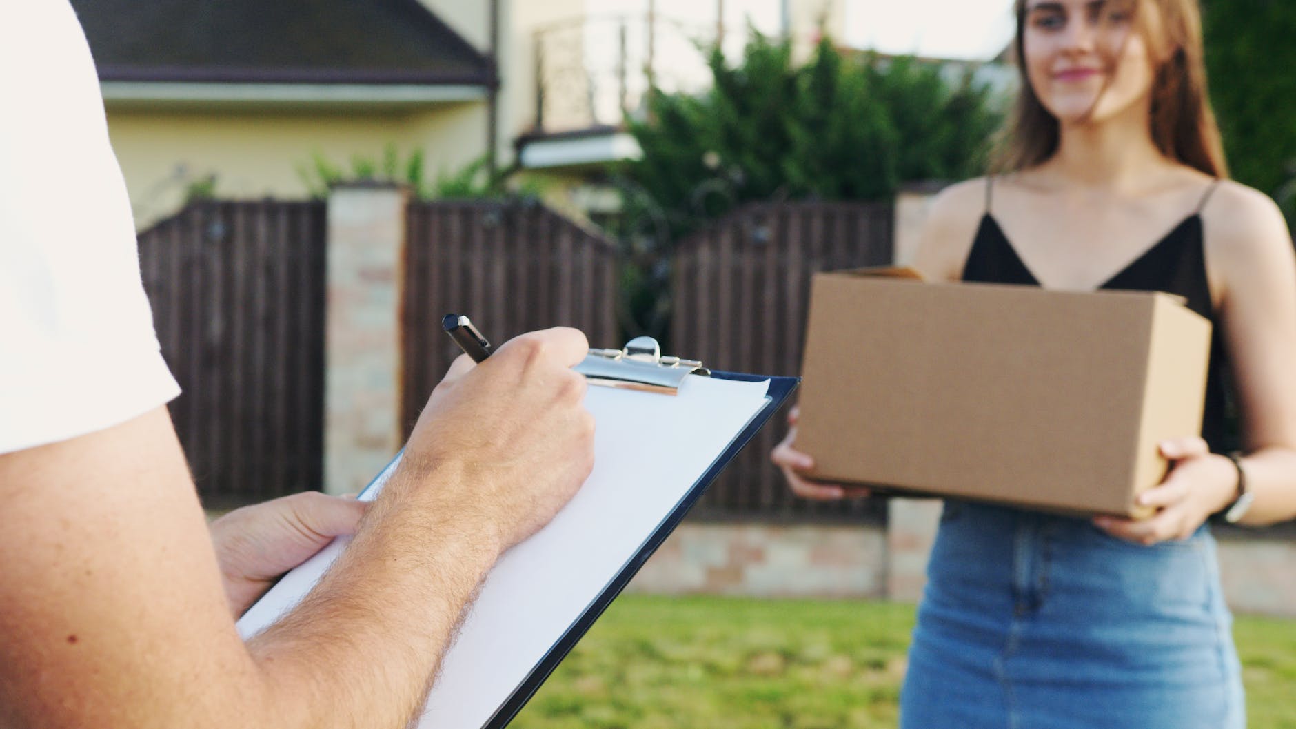 person holding black pen writing on white paper